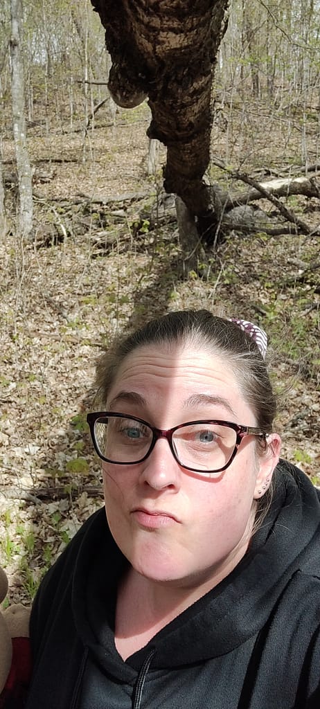 Seleana standing under a down tree on Woodland Nature Loop at Maplewood State Park in Pelican Rapids, MN