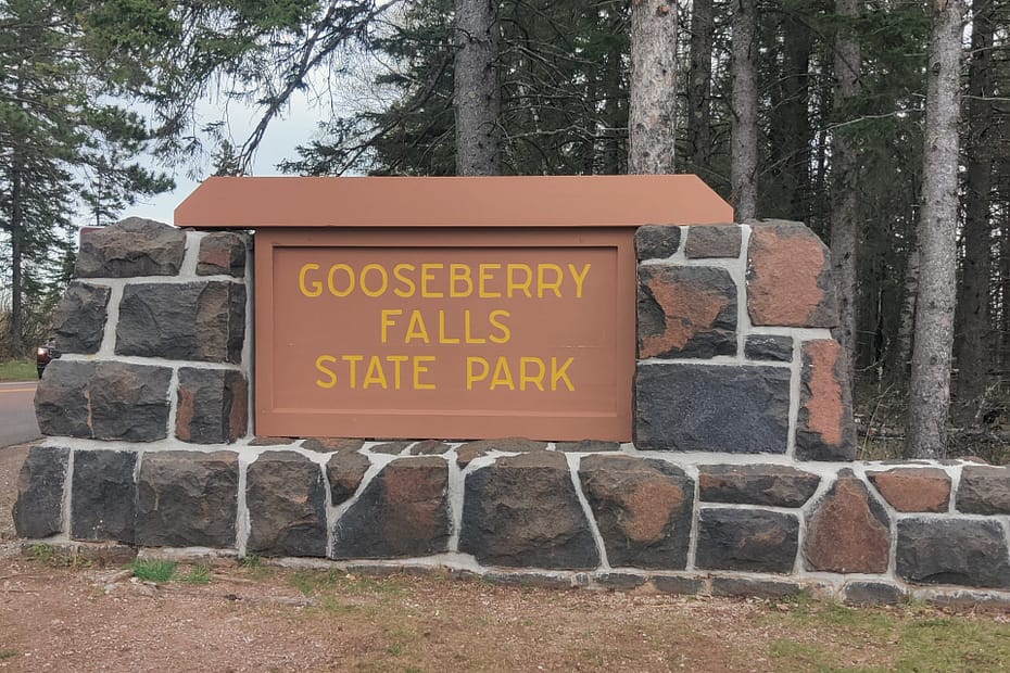 Brown sign with yellow lettering that reads Gooseberry Falls State Park